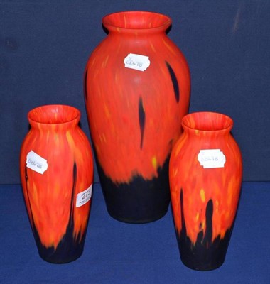 Lot 273 - Large black and red mottled glass vase and a matching smaller pair (3)