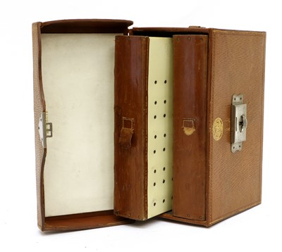 Lot 99 - An Army & Navy Leather Cased Fly Reservoir