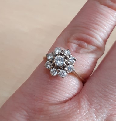 Lot 2188 - A Diamond Cluster Ring the central raised...