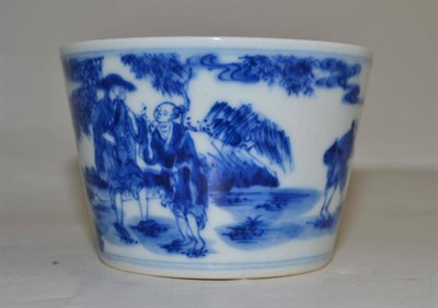 Lot 311 - A blue and white porcelain bucket shaped cup, decorated with a continuous scene of figures,...