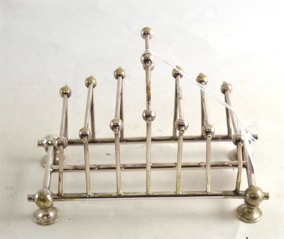 Lot 312 - Plated toast rack in the manner of Christopher Dresser