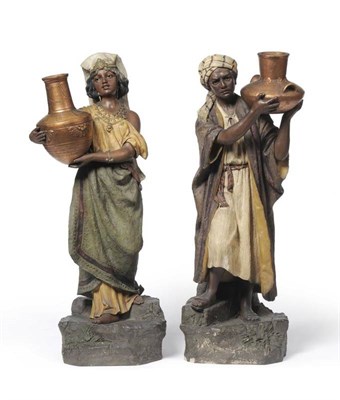 Lot 104 - A Pair of Austrian Painted Terracotta Figures of Nubian Water Carriers, circa 1900, both...