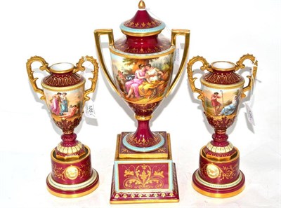 Lot 105 - A Matched Vienna Style Porcelain Garniture, circa 1900, of urn shape with twin handles decorated in