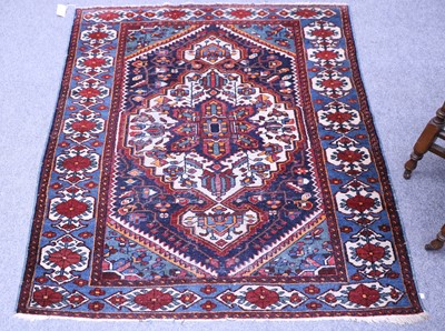 Lot 1180 - A Kurdish Rug, the indigo field of angular...