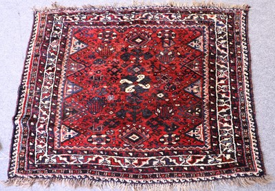 Lot 1173 - A Khamseh Rug, with a brick red field with...