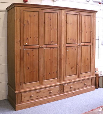 Lot 1141 - A Large Modern Pine Four Door Wardrobe, fitted...