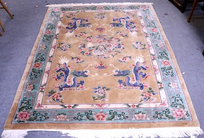 Lot 1189 - A Chinese Carved Carpet, with pale camel field...