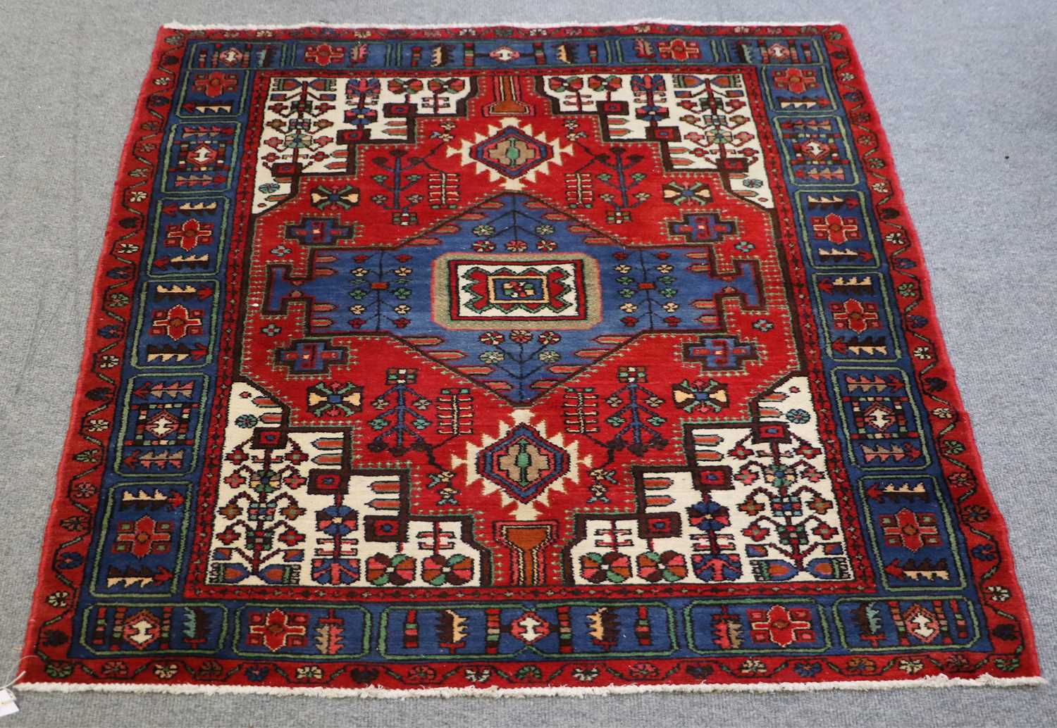 Lot 1000 - A Hamadan Rug, with a blood red field centered...