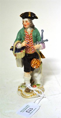 Lot 113 - A Meissen Porcelain Figure of a Grape Seller, late 19th century, standing wearing a tricorn hat and