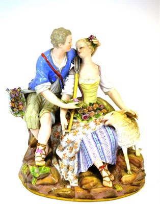 Lot 114 - A Meissen Porcelain Figure Group, late 19th century, as a youth and girl sitting on a rocky outcrop
