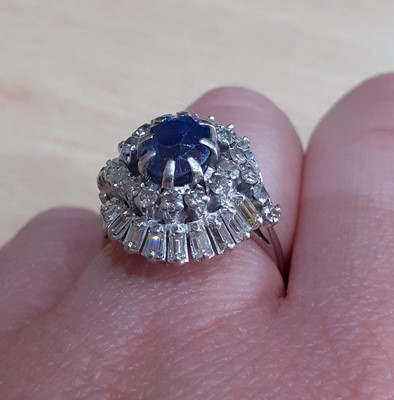 Lot 2078 - A Sapphire and Diamond Cluster Ring the oval...