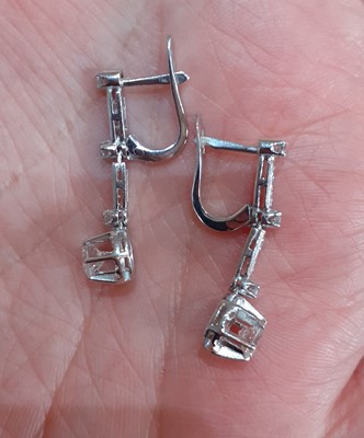 Lot 2080 - A Pair of Diamond Drop Earrings a row of...