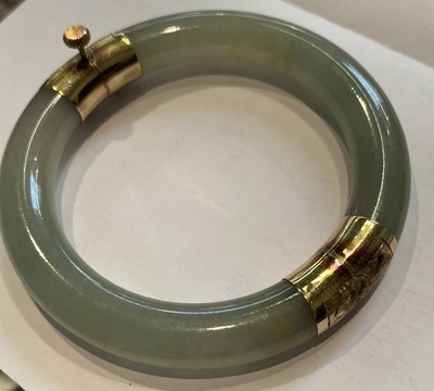 Lot 257 - A Hinged Jade Bangle, inner diameter 5.7cm;...
