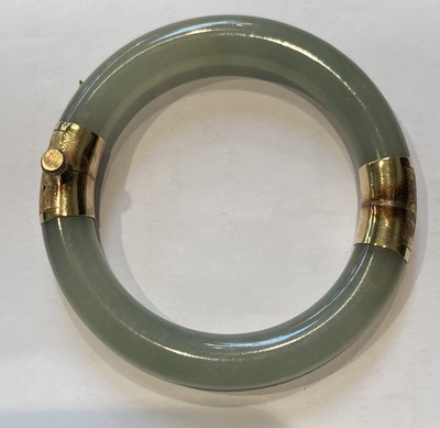 Lot 257 - A Hinged Jade Bangle, inner diameter 5.7cm;...