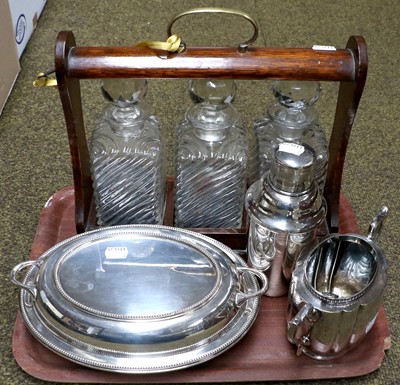 Lot 101 - A silver plated cocktail shaker, three bottle...