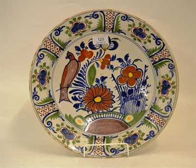 Lot 123 - A Dutch Delft Dish, circa 1730, painted in colours with a parrot amongst chinoiserie foliage within