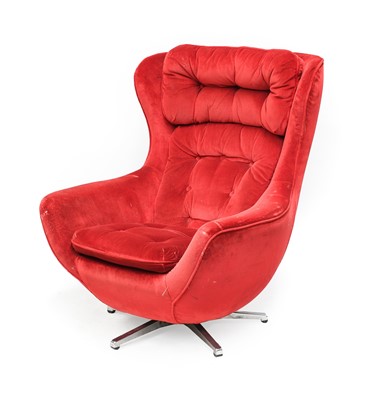 Lot 309 - A 1970s Swivel Lounge Armchair, red velvet...