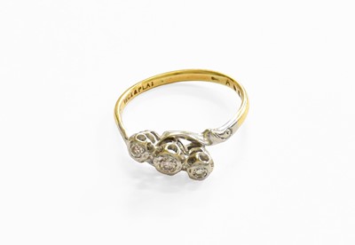 Lot 213 - A Diamond Three Stone Ring, the graduated...