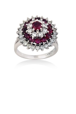 Lot 2058 - A Ruby and Diamond Cluster Ring the central...