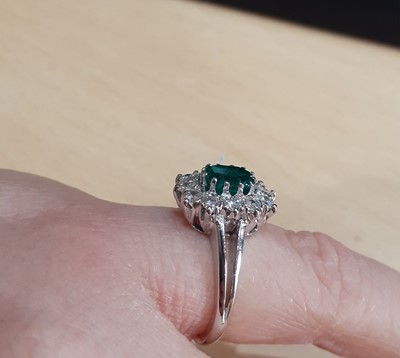 Lot 2092 - An Emerald and Diamond Cluster Ring the...