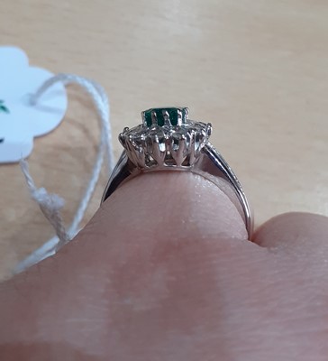 Lot 2092 - An Emerald and Diamond Cluster Ring the...