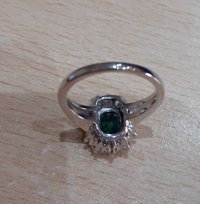 Lot 2092 - An Emerald and Diamond Cluster Ring the...