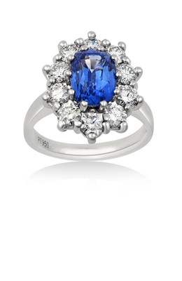 Lot 2308 - A Sapphire and Diamond Cluster Ring the oval...