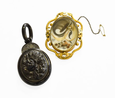 Lot 210 - A Hairwork Mourning Brooch, the oval locket...