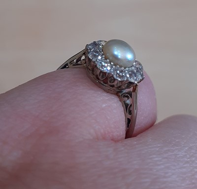 Lot 2154 - A Pearl and Diamond Cluster Ring the pearl...