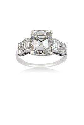 Lot 2320 - A Diamond Ring the central emerald-cut diamond...