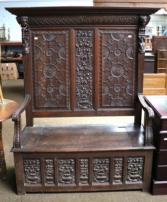 Lot 1069 - An Early 20th Century Carved Oak High Back Box...