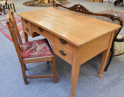 Lot 1136 - A 1920s Light Oak Five Drawer Desk, on square...