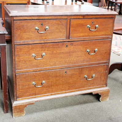 Lot 1207 - A Georgian Oak Three Height Straight Fronted...