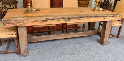 Lot 1145 - A Substantial Oak Rustic Dining Table, the two...