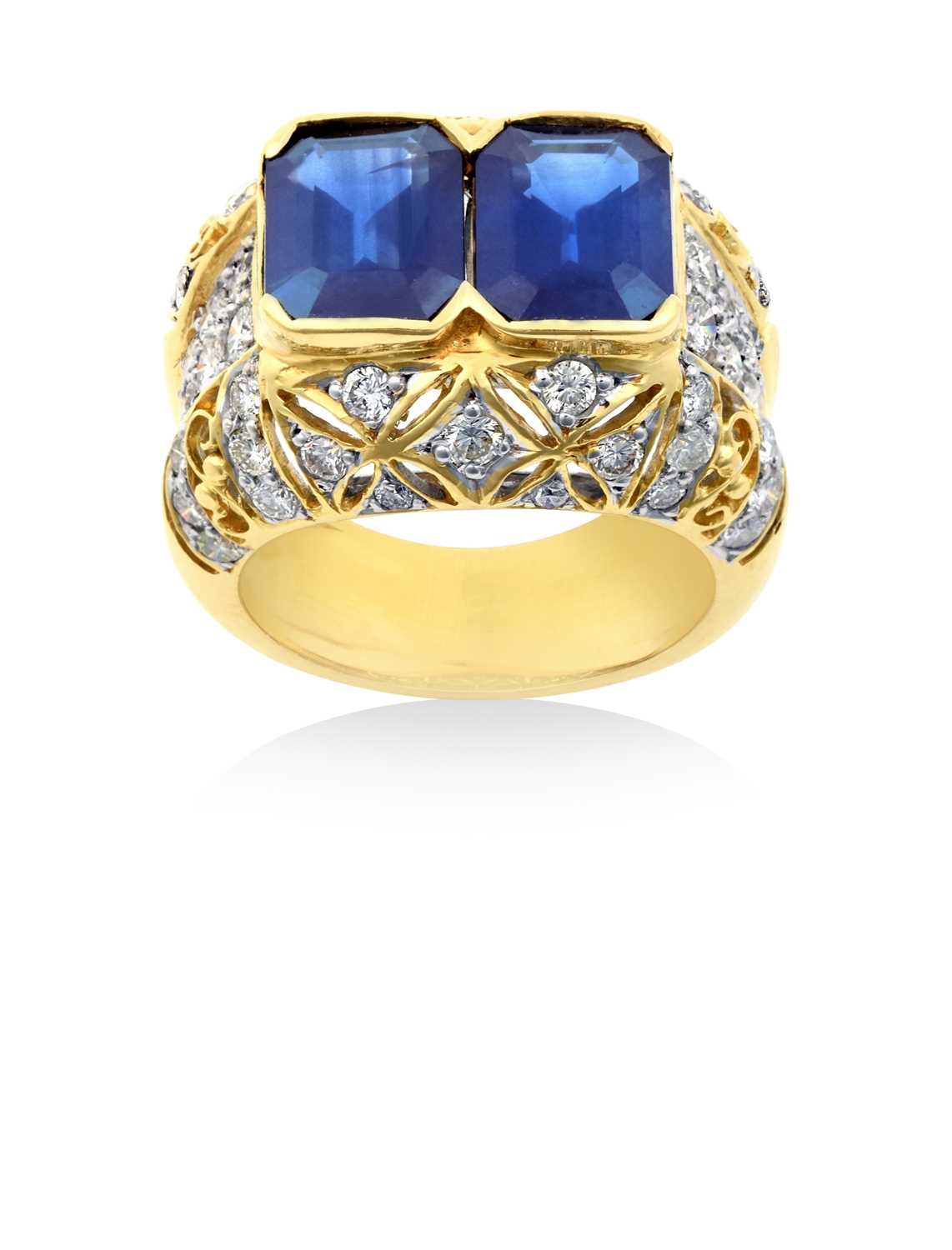 Lot 2263 - A Sapphire and Diamond Ring two emerald-cut...