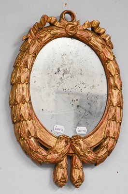 Lot 1259 - A 20th century Oval Wall Mirror, possibly...