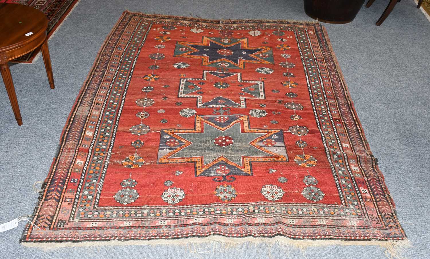 Lot 1094 - A Caucasian Rug, the blood-red field with