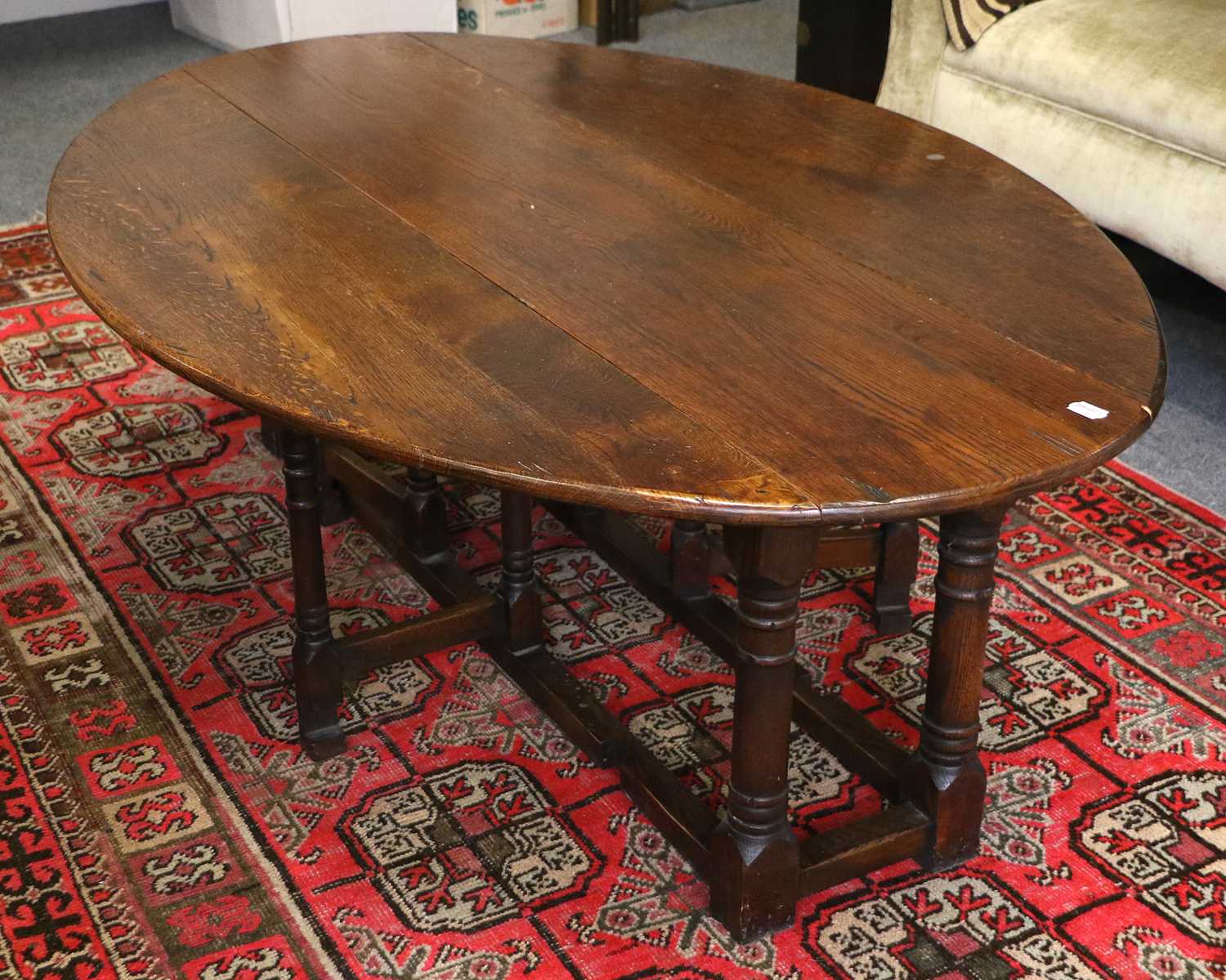 Lot 1115 An Oak Oval Drop Leaf Coffee Table, 17th