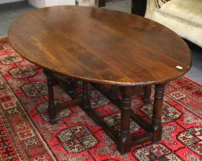 Lot 1130 - An Oak Oval Drop Leaf Coffee Table, 17th...