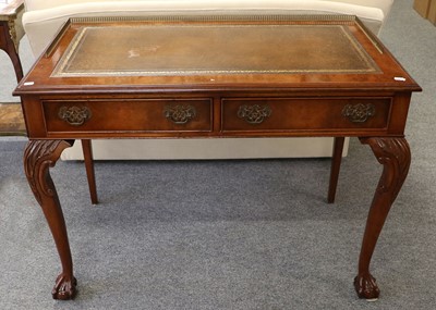 Lot 1077 - A Figured Walnut Leather-Inset Writing Table,...