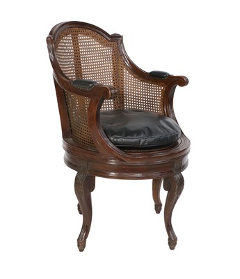 Lot 864 - A Stained Beech and Walnut Swivel Armchair,...