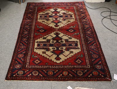 Lot 1035 - A Hamadan Rug, the deep brick red field with...