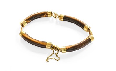 Lot 49 - A Chinese Tiger's Eye Bracelet, the four...