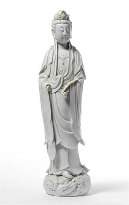 Lot 141 - A Chinese Blanc de Chine Porcelain Figure of Guanyin, 17th/18th century, standing wearing a...