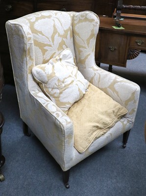 Lot 1277 - An Edwardian Upholstered Wing Armchair