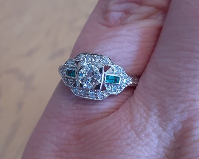 Lot 2014 - An Emerald and Diamond Ring the round...