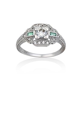 Lot 2014 - An Emerald and Diamond Ring the round...