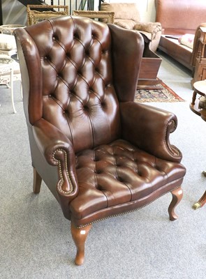 Lot 1162 - Canella: A Reproduction Wing-Back Chair,...