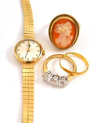 Lot 8 - A 22ct gold band ring (worn), a 9ct gold cameo ring, a cubic zirconia three stone ring and a lady's