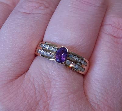 Lot 2030 - An Amethyst and Diamond Ring the oval cut...